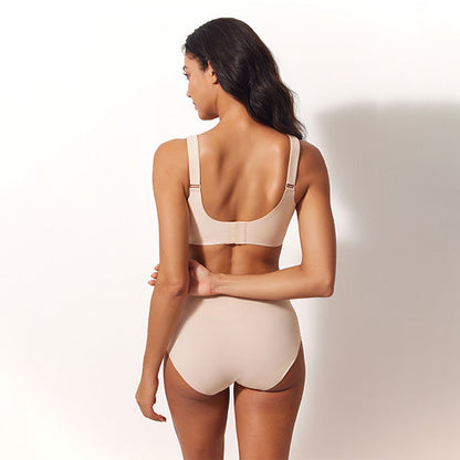 Woman wearing a beige bikini set on a plain background